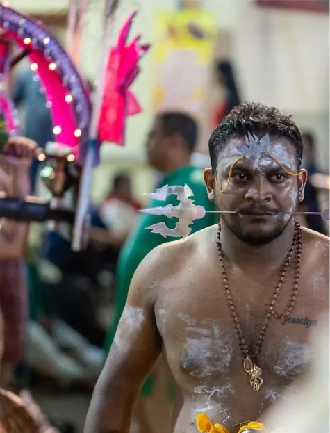 Thaipusam devotee with painted face during the procession
