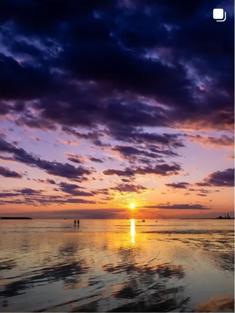 Sunset over shallow Baltic water with dramatic clouds