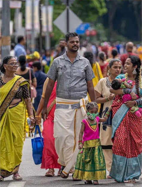 Family walking with the crowd during a street festival