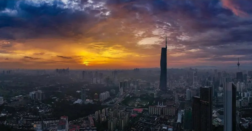Aerial view of the Kuala Lumpur skyline at sunset with Merdeka 118
