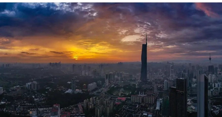 Aerial view of the Kuala Lumpur skyline at sunset with Merdeka 118