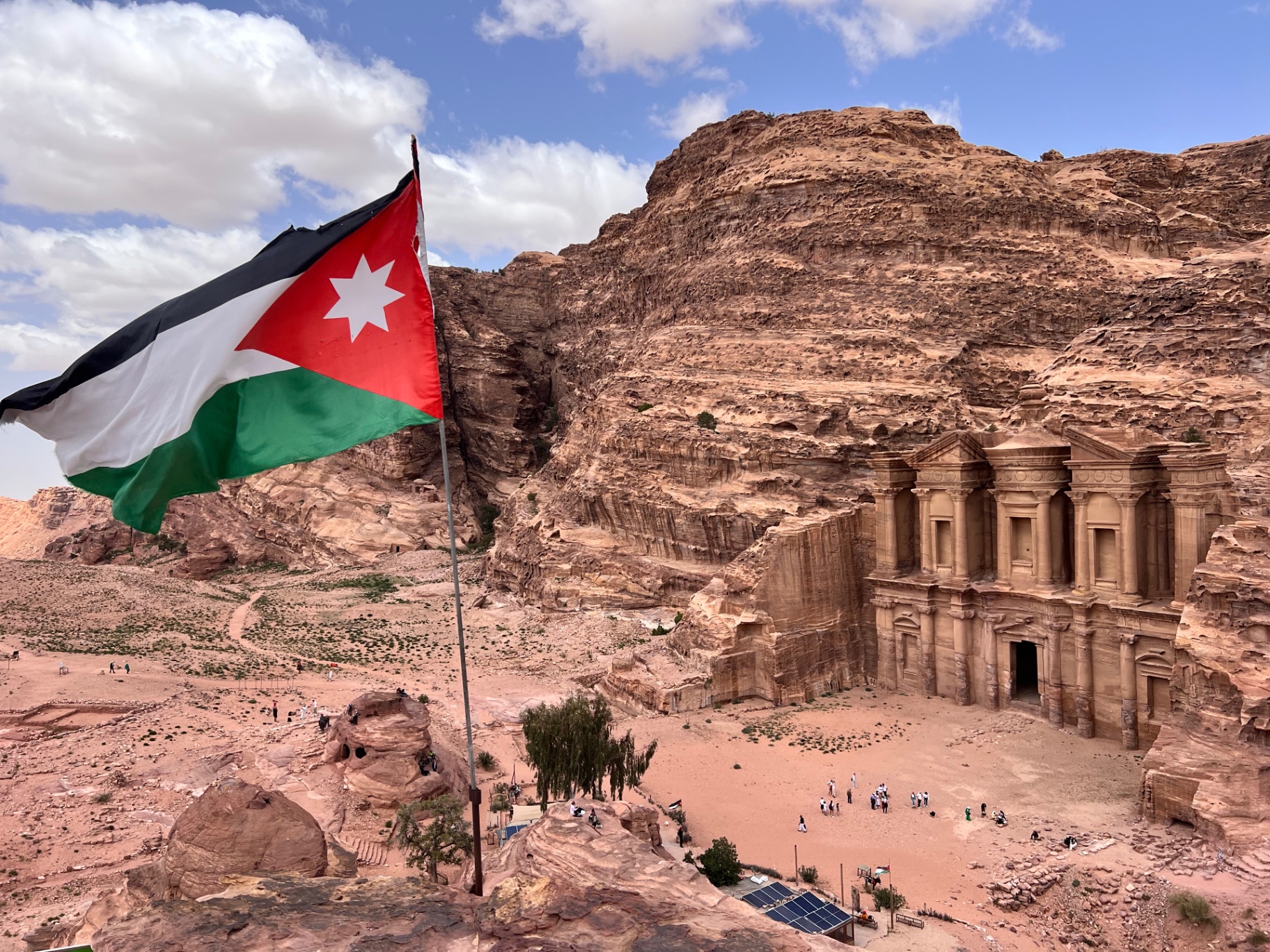 Jordanian flag overlooking the Monastery carved into the cliffs at Petra, Jordan