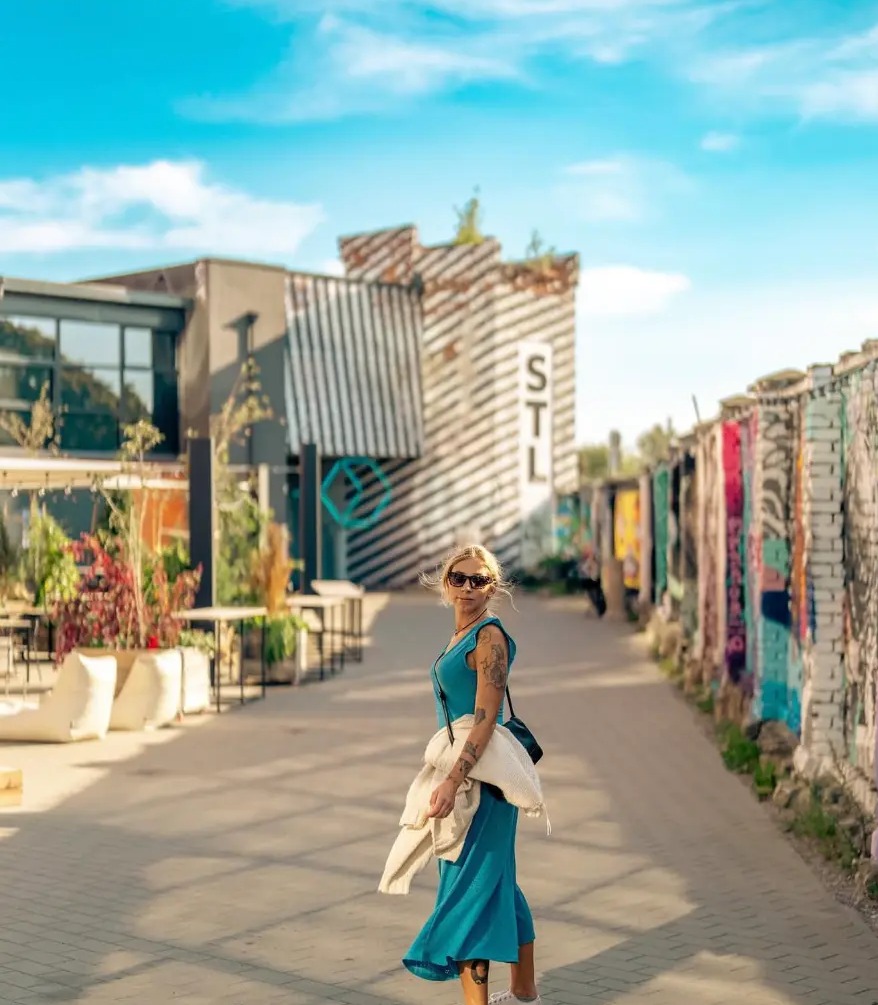 Woman in a teal dress at the Telliskivi Creative City street art walls, Tallinn, Estonia