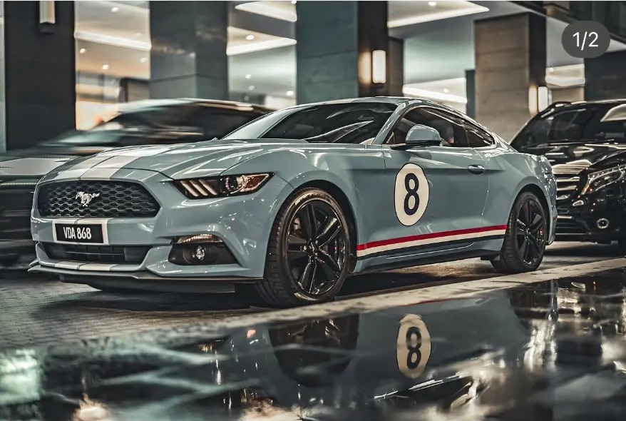 Vintage-liveried Mustang reflected on a wet parking deck