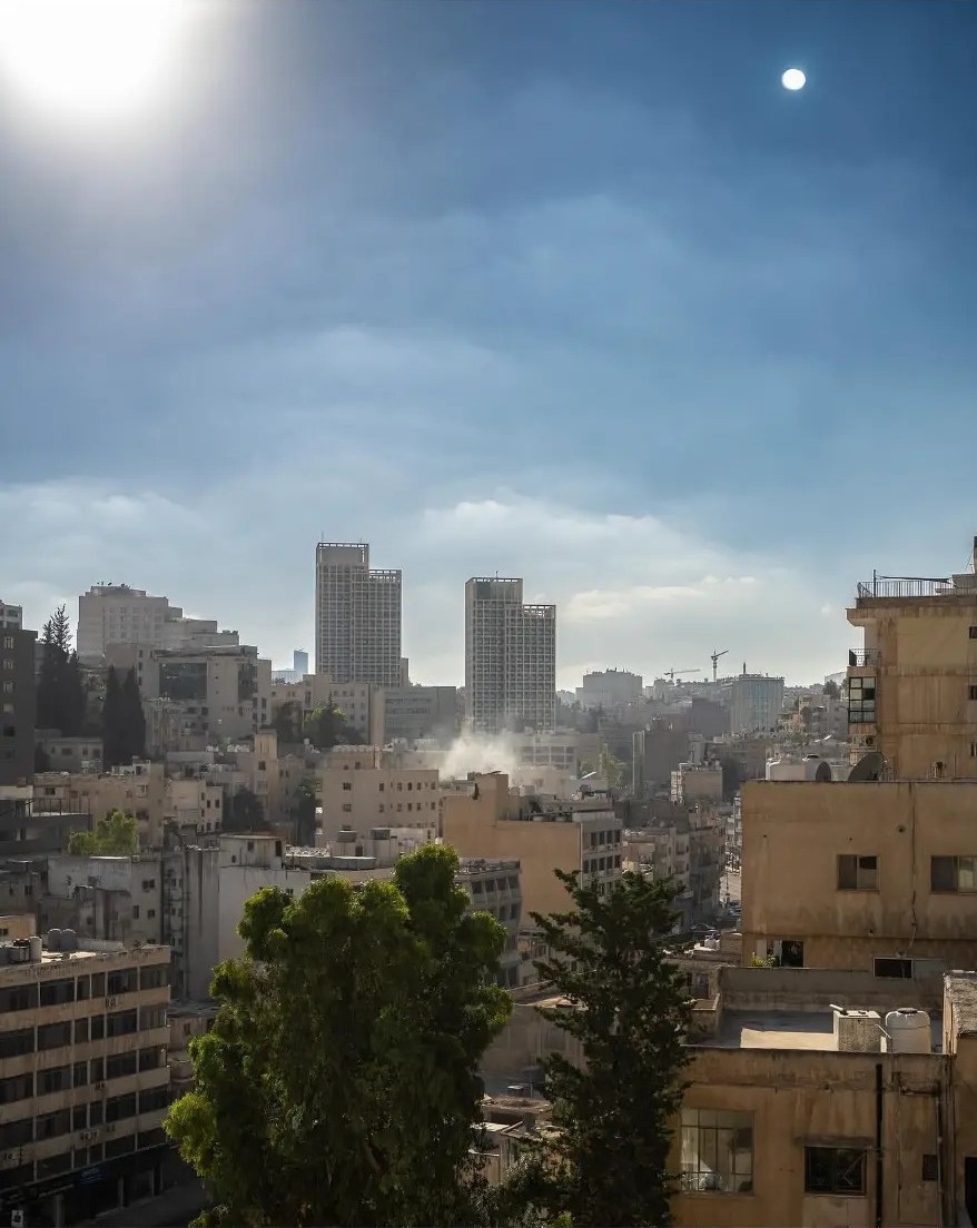 Sunlight over the stone buildings and towers of Amman, Jordan