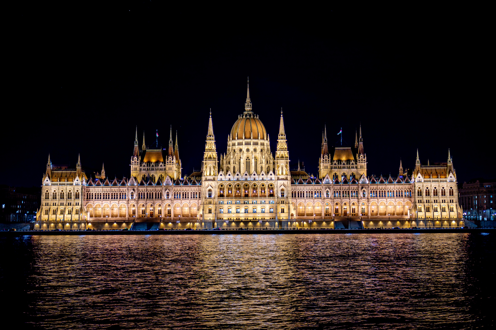 Hungarian Parliament lit up at night, reflected in the Danube, Budapest