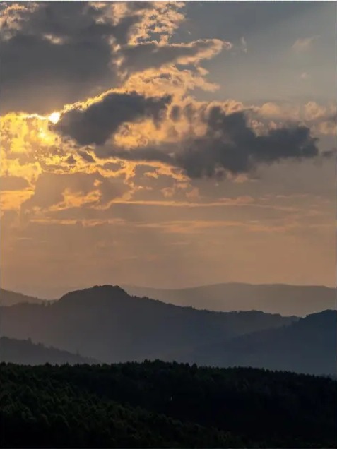 Layered mountain ridges under a glowing evening sky in Eswatini