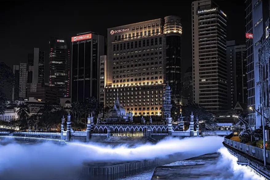 Masjid Jamek and the city skyline reflected in the misted River of Life