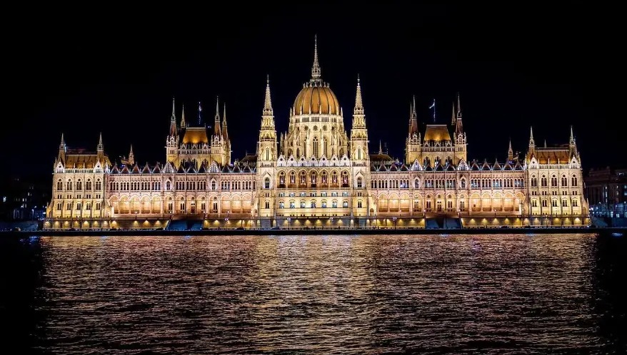 Hungarian Parliament lit up at night, reflected in the Danube, Budapest